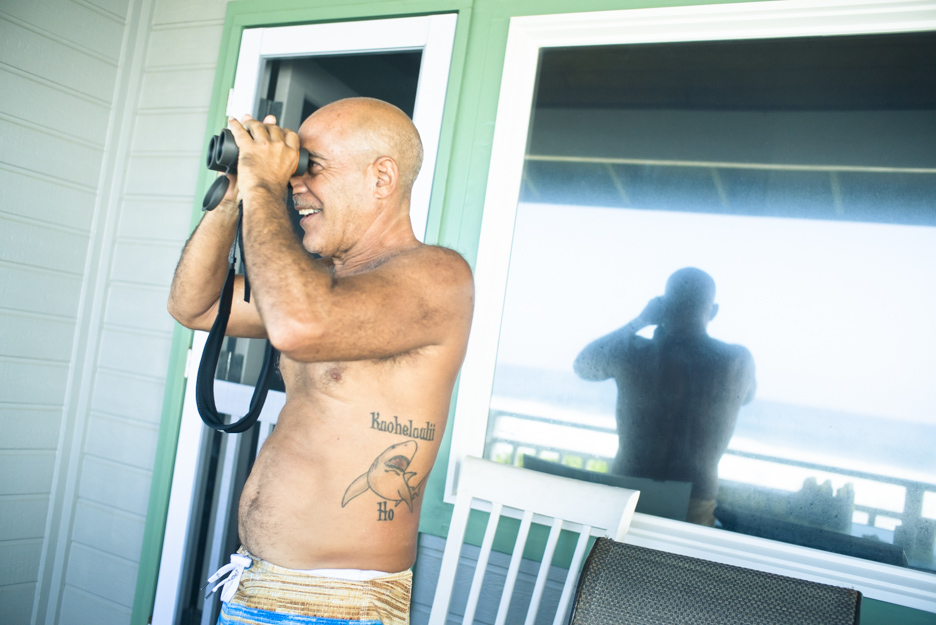 Michael Ho anxiously watches Mason Ho’s Pipe Masters trial heat from the porch of a nearby Pipe patio.