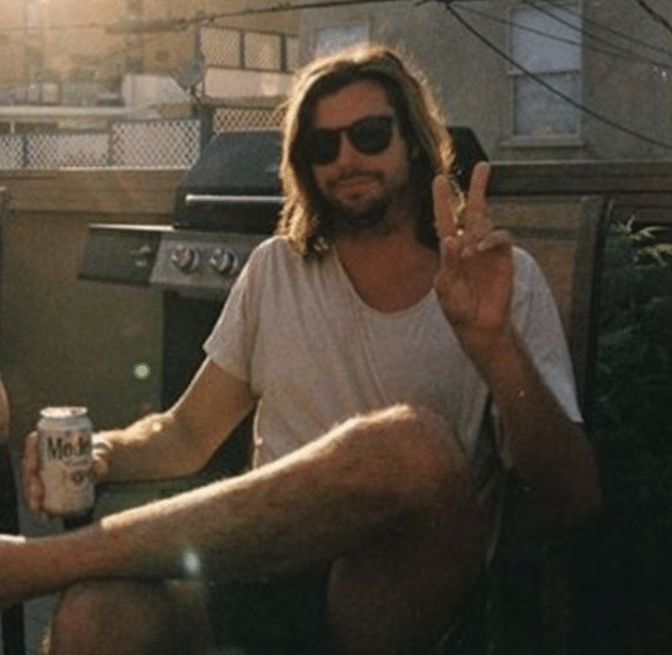 Surfing's poet laureate seen drinking a calorie rich beer and throwing a peace sign.