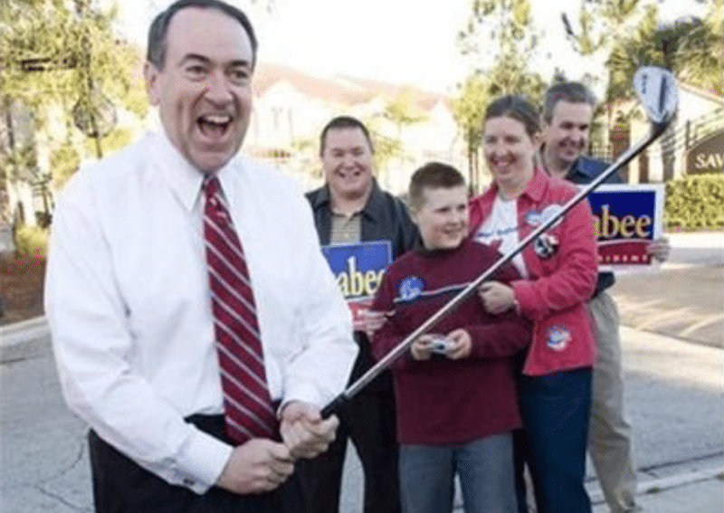 Mike Huckabee (pictured) threatening hopeful surfers with a golf club.