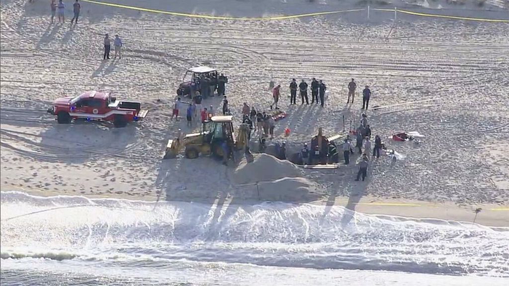 Rescuers work to free buried teenager on Jersey Shore.
