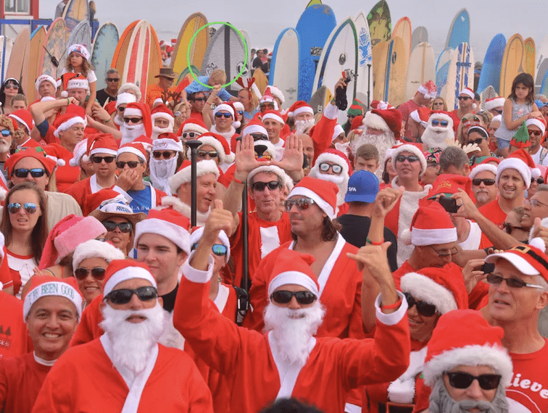 Surfing Santas (pictured) turning back on Kelly Slater statue.