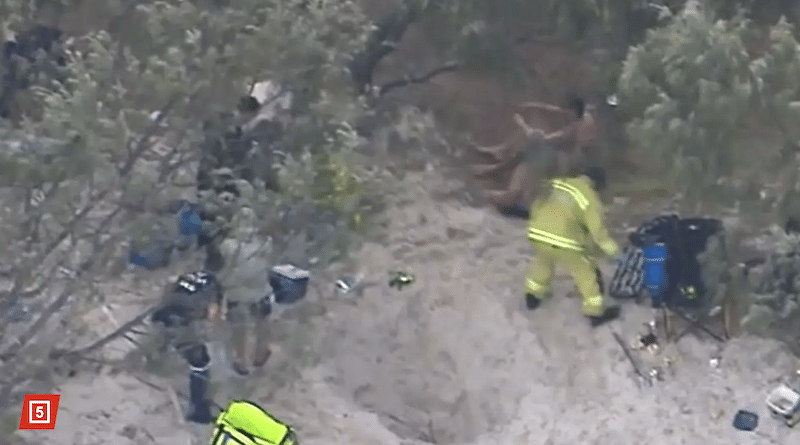 Paramedics attempt to free the buried.