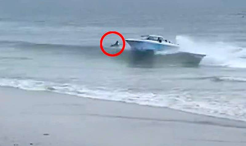 Boatload of migrants arrive in Carlsbad, nearly killing surfer in beach landing.