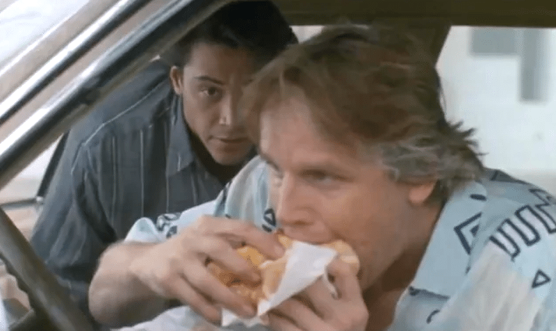 Southern California surf adjacent Angelo Pappas inexplicably eating a meatball sandwich. Photo: Point Break