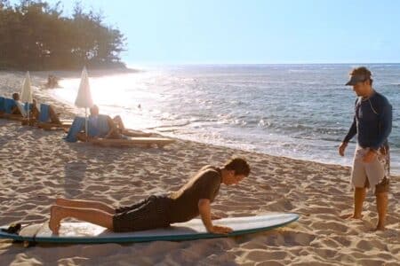 Someone pictured making money teaching someone else to "surf."